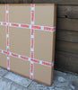 Large fragile cardboard boxes placed against a wooden wall