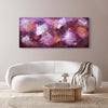 Vibrant abstract landscape painting in shades of purple, red, and orange displayed above a modern white sofa in a minimalist living room setting.