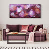 Large abstract artwork with vibrant purple, pink, and red hues displayed above a plush purple sofa with matching decorative pillows in a modern living room setting.