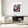 Minimalist Abstract Art | Firedance I 100x100cm
Monochrome black and white painting with red accents, framed canvas art piece displayed in modern living room setting.