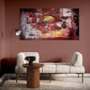 Large abstract landscape painting depicting the edge of a dream in earthy tones of red, brown, and yellow on display in a modern living room setting with a white sofa and wooden side table.