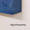 Blue abstract painting with visible brushstrokes on a white wall