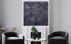 Large abstract taupe canvas art titled "Shades of Stillness" displayed in a modern living room setting with black leather chairs and a coffee table.