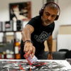 Abstract artist at work creating large-scale contemporary painting in his studio