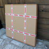 Stacked fragile cardboard boxes on wooden background