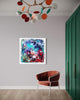 Vibrant abstract artwork on wall with colorful lighting fixture