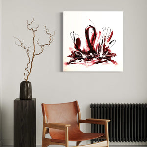 Expressive abstract painting with vibrant red and black brush strokes on a white canvas, displayed on a wall alongside a vase with a twisted twig, and a wooden chair.