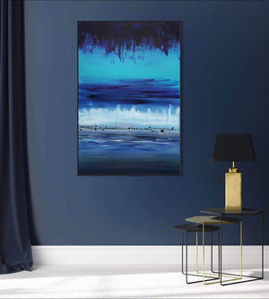 Vibrant abstract landscape painting "Night Illusion 80x120cm" by artist Paresh Nrshinga, showcasing a serene, tranquil seascape with calming blue hues and textured brushstrokes, displayed on a dark wall in a minimalist modern home setting.