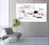 Large abstract landscape art in earthy tones on the wall above a gray modern sofa with a potted plant in the image.