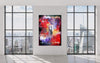 Colorful abstract artwork, "Forgotten World 150x200cm", displayed in modern art gallery with cityscape visible through large windows