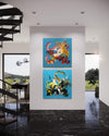 Diptych painting | Summer In The City I and II 40x80"
Two large, colorful abstract paintings hang on the white wall in a modern, minimalist interior setting. The artworks feature bold, vibrant brush strokes in a range of earthy tones and complementary colors, creating a dynamic and visually striking display.