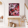 Large abstract canvas art depicting a vibrant, colorful floral landscape in purple, red, and white hues. The painting is displayed on a white wall in a minimalist, modern interior setting with wooden furniture accents.