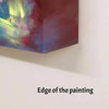 Vibrant abstract painting with colorful brushstrokes displayed on a wall