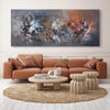 Vibrant abstract landscape painting of earthy tones and textures, displayed on the wall of a modern living room with comfortable tan leather sofa and minimalist furnishings.