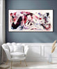 Extra Large Canvas Painting | Snowflake Waltz 30x60"
Vibrant abstract artwork with swirling colors and dynamic movement, displayed on a grey wall in a minimalist living room setting with a white armchair.