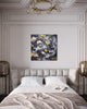 Large abstract artwork with golden snowflake motif in a luxurious bedroom setting with ornate architectural details and a chandelier.