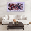 Vibrant abstract landscape artwork | Captivating large canvas painting featuring swirling, colorful brushstrokes in shades of red, black, and white displayed above a modern white sofa and dark wooden coffee table in a minimalist living room setting.