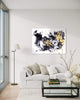 Expressive Abstract Art | Golden Dust 36x48" - Large abstract painting displayed on the wall in a modern living room setting with a gray sofa, floor lamp, and decorative accessories.