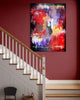 Vibrant abstract artwork titled "Forgotten World" displayed on a wall along a staircase. The painting features a mix of bold, colorful brush strokes in red, purple, and blue hues, creating a dynamic and expressive modern art piece.
