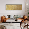 Large gold-framed abstract landscape painting adorning a cozy living room with a brown leather sofa, plush throw pillows, and a stylish woven rug.