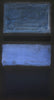 Large abstract painting with rectangular shapes in shades of blue on a dark background