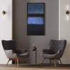 Large abstract Rothko artwork in silver taupe colors on wall between two modern gray upholstered chairs and a side table with decorative vase.