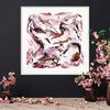 Large Abstract Art | Dream A Little Dream 30x30" - Vibrant pink and white abstract painting displayed in a white frame, surrounded by pink and green floral arrangements.