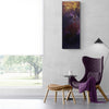 Large abstract landscape painting "Dusk Till Dawn I" in rich purple and gold tones, displayed on the wall of a modern, minimalist living room with a purple upholstered armchair and wooden stool.