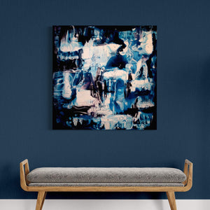 Large abstract painting with earthy blue and brown tones displayed on the wall above a wooden bench in a minimalist room setting.