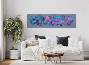Large abstract painting with vibrant colors and organic shapes in shades of blue, pink, and gray, displayed on the wall above a white sofa in a modern living room setting.