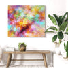 Vibrant abstract landscape | Chasing Rainbows 24x28"
A vibrant, colorful abstract painting featuring a blend of vivid hues and dynamic brushstrokes, creating a captivating landscape artwork. The multicolored artwork is displayed on a wall in an interior setting, complemented by a potted plant, books, and a rustic wooden bench.