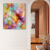 Vibrant abstract landscape | Chasing Rainbows 24x28" - Colorful acrylic painting displayed on the wall of a modern interior with a view of the room beyond.