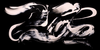 Abstract black and white artwork depicting fluid, dynamic shapes on a dark background