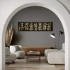 Elegant modern living room with abstract calligraphy artwork on the wall, wooden bench, and minimal decor elements.
