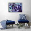 Large abstract landscape art with bold, expressive brushstrokes in shades of blue and purple, displayed in a modern, minimalist living space with navy blue and white striped seating.