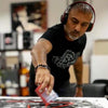Energetic abstract artist at work in the studio, meticulously crafting large canvas painting with bold brushstrokes and vibrant colors, showcasing passion and creativity.