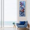 Large abstract painting with bold blue, red, and white brushstrokes displayed on the wall of a modern living room with a large window and a comfortable gray armchair.