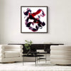 Large abstract painting of bold red, black, and pink brushstrokes displayed in a modern living room setting with neutral-toned furniture.