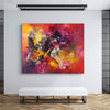 Vibrant abstract art piece depicting energetic brushstrokes and vivid colors, showcased in a modern interior setting.