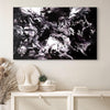 Large monochrome abstract artwork with fluid, dynamic brushstrokes in black and white displayed on a wall with minimalist home decor items.