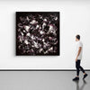 Striking abstract landscape in black, white, and purple tones displayed on gallery wall, complemented by a single person viewing the artwork.