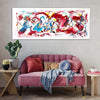Large abstract canvas art featuring vibrant splashes of red, blue, and yellow colors, displayed on the wall above a cozy pink velvet sofa with decorative pillows and a potted cactus nearby, creating a modern and stylish living room setting.