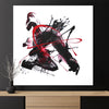 Minimalist abstract art piece with bold black and red brushstrokes, showcased on a wooden shelf.