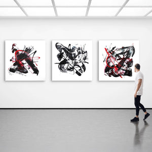 Abstract landscape triptych artwork featuring dynamic black, white, and red brushstrokes on large canvases displayed in a modern art gallery.