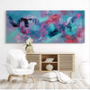 Colorful abstract landscape painting of dreamcatcher design with swirling floral patterns in vibrant blue, pink, and purple hues displayed on the wall above a modern wooden media console with white decor elements in the living room setting.