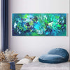 Vibrant abstract landscape painting titled "Emerald City" displayed on the wall, featuring a dynamic composition of lush green and blue hues, creating a serene and tranquil atmosphere. The large 30x72" canvas artwork would make an impactful addition to any modern or contemporary living space.