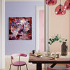 Extra large abstract painting depicting vibrant colors and textures, hanging on the wall of a modern, colorful dining room with pink furniture and glass pendant lights.