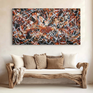 Vibrant abstract landscape painting titled "Earth Rhythm" by Paresh Nrshinga displayed on the wall above a rustic wooden sofa with neutral-colored pillows and throw.