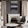 Large abstract painting in moody gray tones on wall above marble fireplace mantel, flanked by curtained windows. Armchair and coffee table in front of fireplace in modern, minimalist room decor.