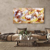 Extra large abstract landscape painting of vibrant orange, yellow, and brown hues displayed above a cozy living room setting with a plush sectional sofa, wooden coffee table, and potted plant accents.